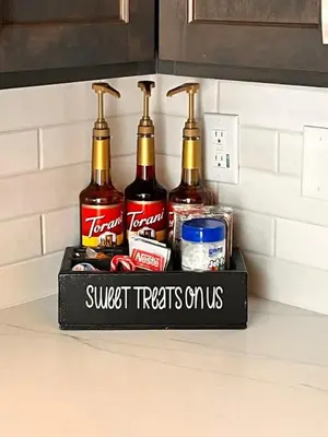 a shelf with four bottles of alcohol on a kitchen counter at Adorable little cabin #21 in Kernville
