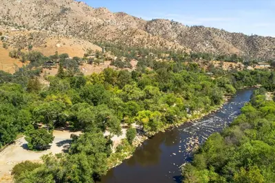 an aerial view of a river with trees and mountains at Adorable little cabin #21 in Kernville