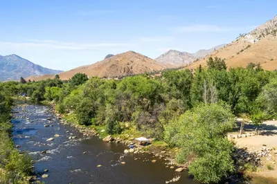 a river with trees and mountains in the background at Adorable little cabin #26 in Kernville