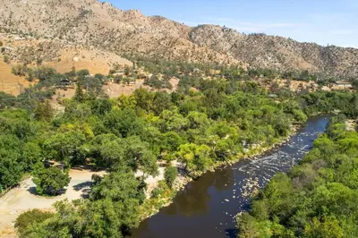 an aerial view of a river with trees and mountains at Adorable little cabin #28 in Kernville