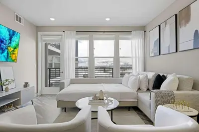 a living room with a bed and a couch at Designer Apt w Jacuzzi Walk To Casino & iMax in Sparks
