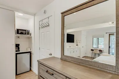 a large mirror in a room with a bedroom at Crystal Bay Comfort in Incline Village