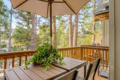 a wooden table with an umbrella on a deck at Crystal Bay Comfort in Incline Village