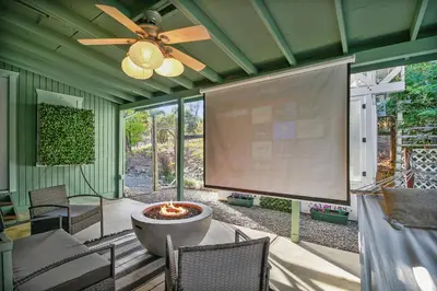 a large screen in a screened in porch with a large screen at Fully-Stocked, Pet-friendly, Relaxing Home Near Yosemite and Bass Lake in North Fork