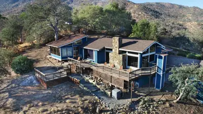an aerial view of a blue house in the mountains at Mountain View, Hot Tub, Open Kitchen, 10m to Sequoia in Three Rivers