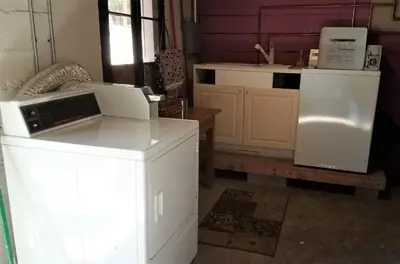 a kitchen with white cabinets and a white refrigerator at Modern lofty studio in Midtown / Charming Old SW in Reno