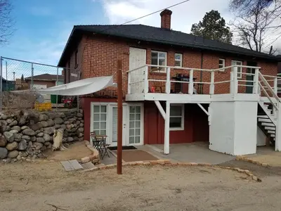 a red brick house with a balcony and a staircase at Modern lofty studio in Midtown / Charming Old SW in Reno