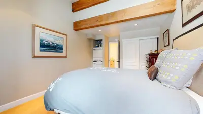 a bedroom with a large blue bed in a room at Summit #92 condo in Mammoth Lakes