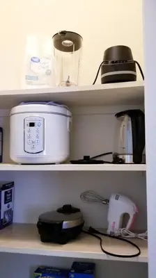 a kitchen shelf with some appliances on it at Chateau Sunnyside in Fresno
