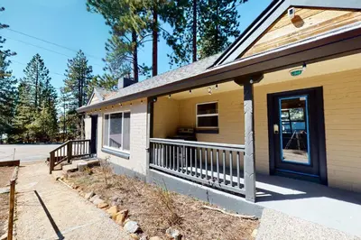 a yellow house with a porch and a door at The Chalet at Kings Beach 9 in Kings Beach