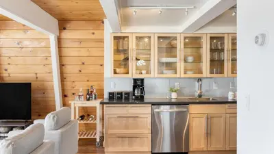 a kitchen with wooden cabinets and a sink at Chickaree Chickadee Buyout by AvantStay 2 Sister Cabins in Tahoe City