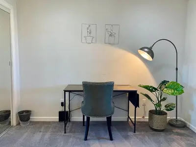 a desk with a chair and a lamp and a plant at Mountain Escape, Yosemite South Gate House with Hot Tub, Views & Game Room, Near town in Oakhurst