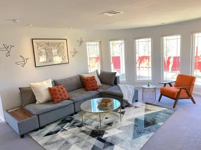 a living room with a couch and a glass table at Mountain Escape, Yosemite South Gate House with Hot Tub, Views & Game Room, Near town in Oakhurst