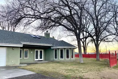 a green house with a tree in the yard at Mountain Escape, Yosemite South Gate House with Hot Tub, Views & Game Room, Near town in Oakhurst