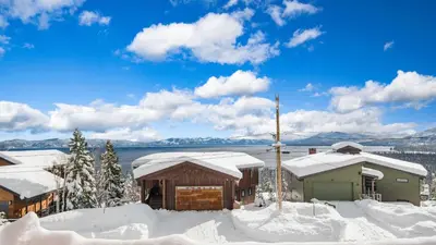 a cabin in the snow with snow covered roofs at Chickadee by AvantStay Modern A-Frame Cabin in Tahoe City