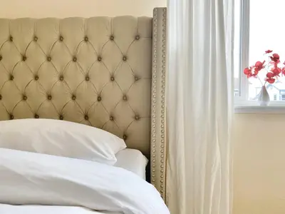 a bedroom with a bed with a large headboard and a window at Reno Gem 3 and a half Miles to DT, 40 Miles to Tahoe in Reno