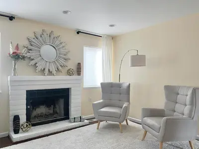 a living room with two chairs and a fireplace at Reno Gem 3 and a half Miles to DT, 40 Miles to Tahoe in Reno