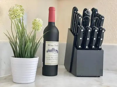 a bottle of wine next to a wine knife block at Reno Gem 3 and a half Miles to DT, 40 Miles to Tahoe in Reno
