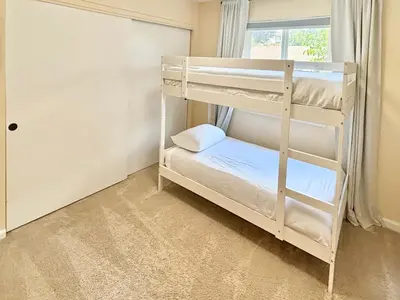 a bedroom with two bunk beds and a window at Reno Gem 3 and a half Miles to DT, 40 Miles to Tahoe in Reno