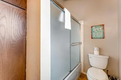 a bathroom with a toilet and a glass shower door at Fairway Forest in Incline Village