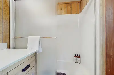 a white shower in a bathroom with a sink at Talmont Trailhead Cabin in Tahoe City