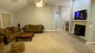 a living room with two couches and a fireplace at Beautiful peaceful desirable home in Madera Rancho in Madera