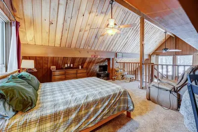 a bedroom with a bed and a wooden ceiling at Lofty Lodi in South Lake Tahoe