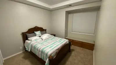 a small bedroom with a bed and a window at Beautiful peaceful desirable home in Madera Rancho in Madera