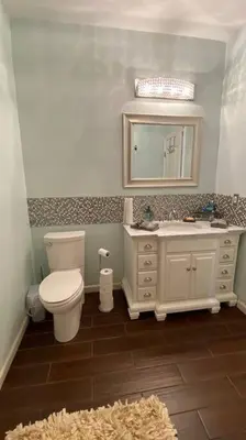 a bathroom with a toilet and a sink and a mirror at Beautiful peaceful desirable home in Madera Rancho in Madera
