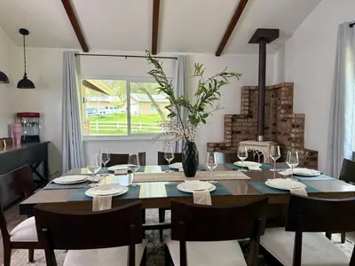 a dining room with a table with chairs and a vase at The Happy Cabin w/ hot tub in Oakhurst