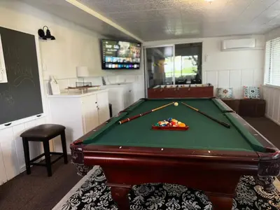 a room with a pool table in a kitchen at The Happy Cabin w/ hot tub in Oakhurst