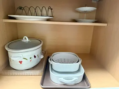 a kitchen shelf with bowls and plates on it at The Happy Cabin w/ hot tub in Oakhurst