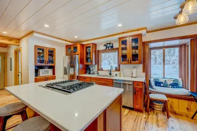 a kitchen with wooden cabinets and a white counter top at A Bear's Rest in Homewood