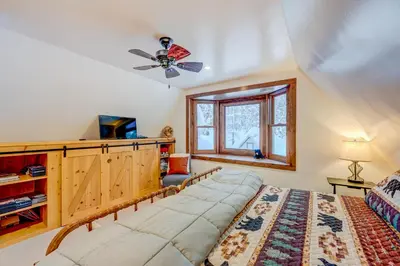 a bedroom with a large bed and a ceiling fan at A Bear's Rest in Homewood