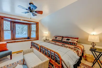 a bedroom with a bed and a ceiling fan at A Bear's Rest in Homewood