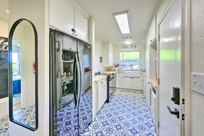 a kitchen with a blue and white tile floor at Peaceful Ranch Home with Sierra Nevada Views in Woodlake