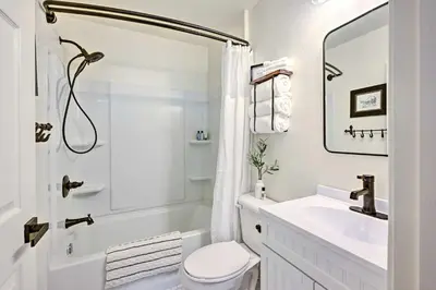 a white bathroom with a sink and a toilet at Peaceful Ranch Home with Sierra Nevada Views in Woodlake