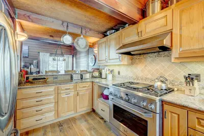 a kitchen with wooden cabinets and a stove top oven at Rocky Revival in Truckee