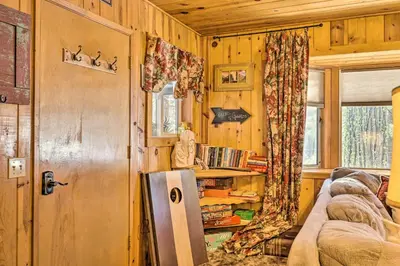 a living room with a couch and a window at California Retreat with Deck, Fire Pit and Grill! in Long Barn