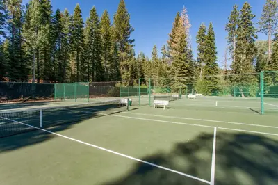 a tennis court with two benches on it at Silver Strike Serenity in Truckee