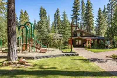 a playground in a park next to a building at The Pines at Rocky Point in Truckee