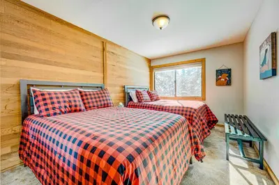a bedroom with two beds and a window at The Pines at Rocky Point in Truckee