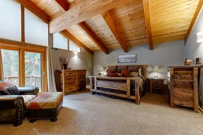 a bedroom with a bed and a wooden ceiling at A Slice of Silver Fir in Truckee