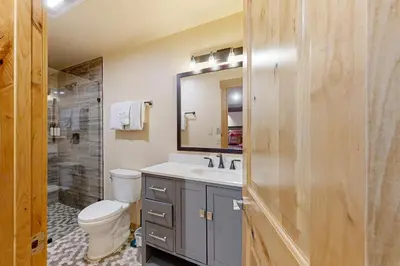 a bathroom with a toilet and a sink and a mirror at A Slice of Silver Fir in Truckee