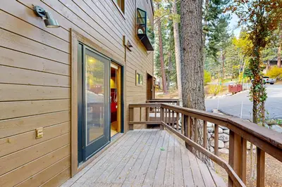 a wooden porch with a door on a house at A Slice of Silver Fir in Truckee