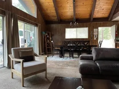 a living room with a couch and a table at Close To Heaven With Hot Tub, Wet Bar & Game Room in South Lake Tahoe
