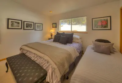 a bedroom with two beds and a window at Enviable Lake & Mountain Views Wth Waterfall in South Lake Tahoe