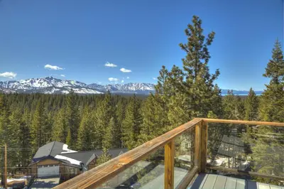 a balcony with a view of the mountains at Enviable Lake & Mountain Views Wth Waterfall in South Lake Tahoe