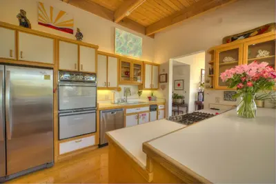 a kitchen with a vase of flowers on a counter at Enviable Lake & Mountain Views Wth Waterfall in South Lake Tahoe