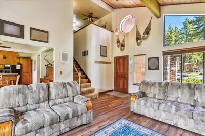a living room with two couches and a staircase at Minutes From Heavenly Valley & Lake Tahoe Beaches in South Lake Tahoe